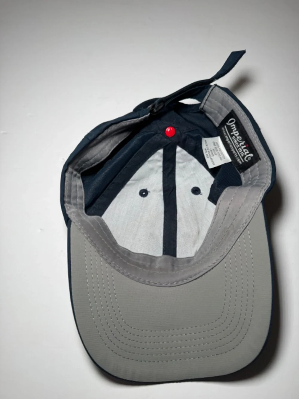 Description: Imperial golf cap in navy blue featuring an embroidered 2027 PGA Fr